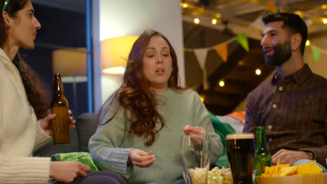 Group-Of-Friends-At-Home-Or-In-Bar-Celebrating-At-St-Patrick's-Day-Party-Drinking-Alcohol-And-Catching-Popcorn-In-Mouth